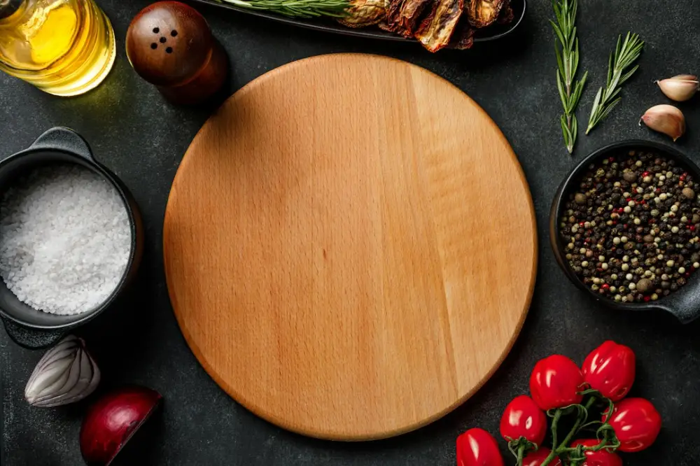 A wooden cutting board surrounded by various ingredients, illustrating understanding ingredients through simple dishes